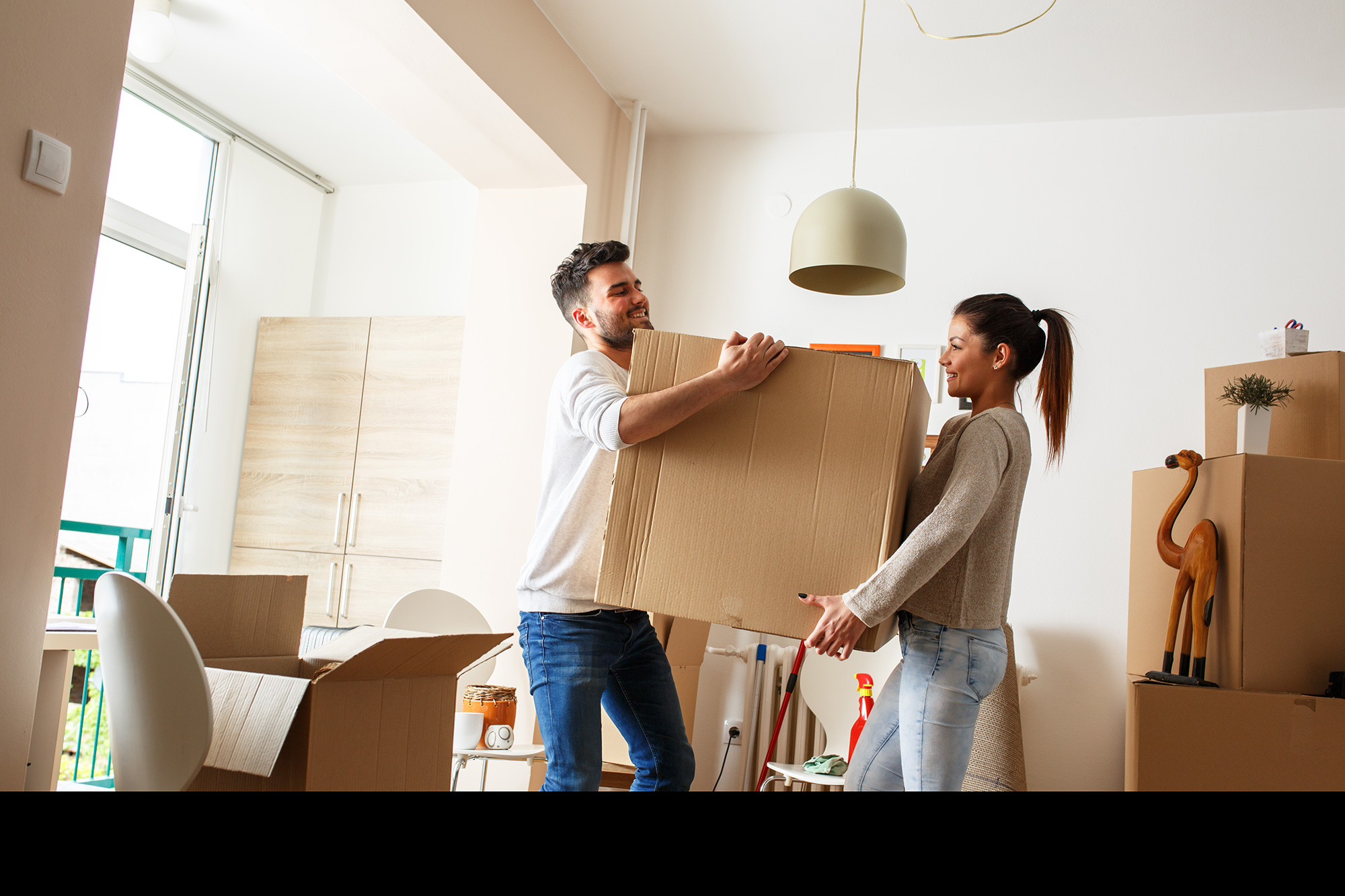 Couple moving a box.