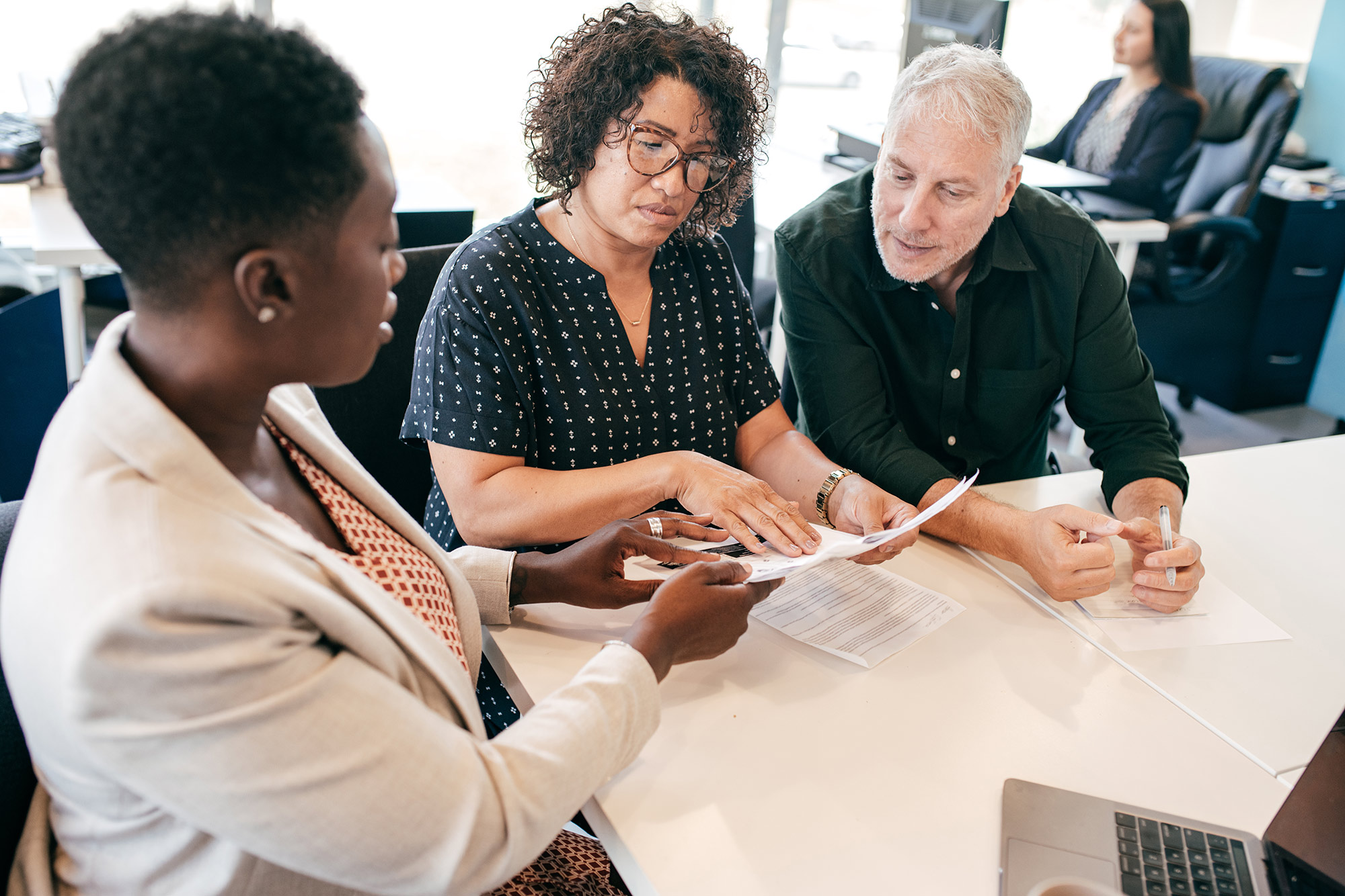 A couple seated at a table with an independent insurance agent.