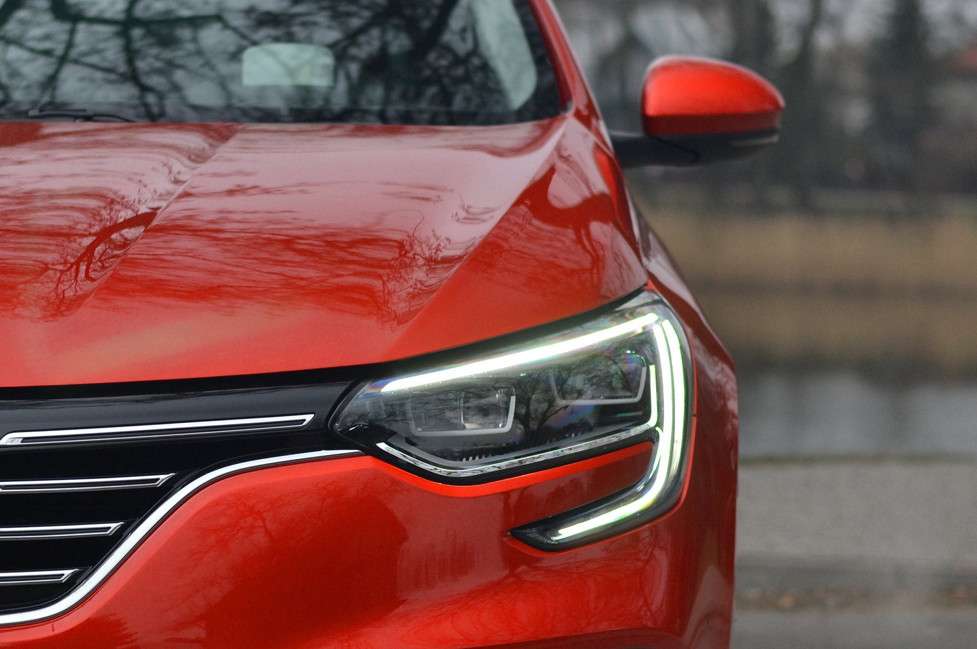 Close up of the front of a red car.