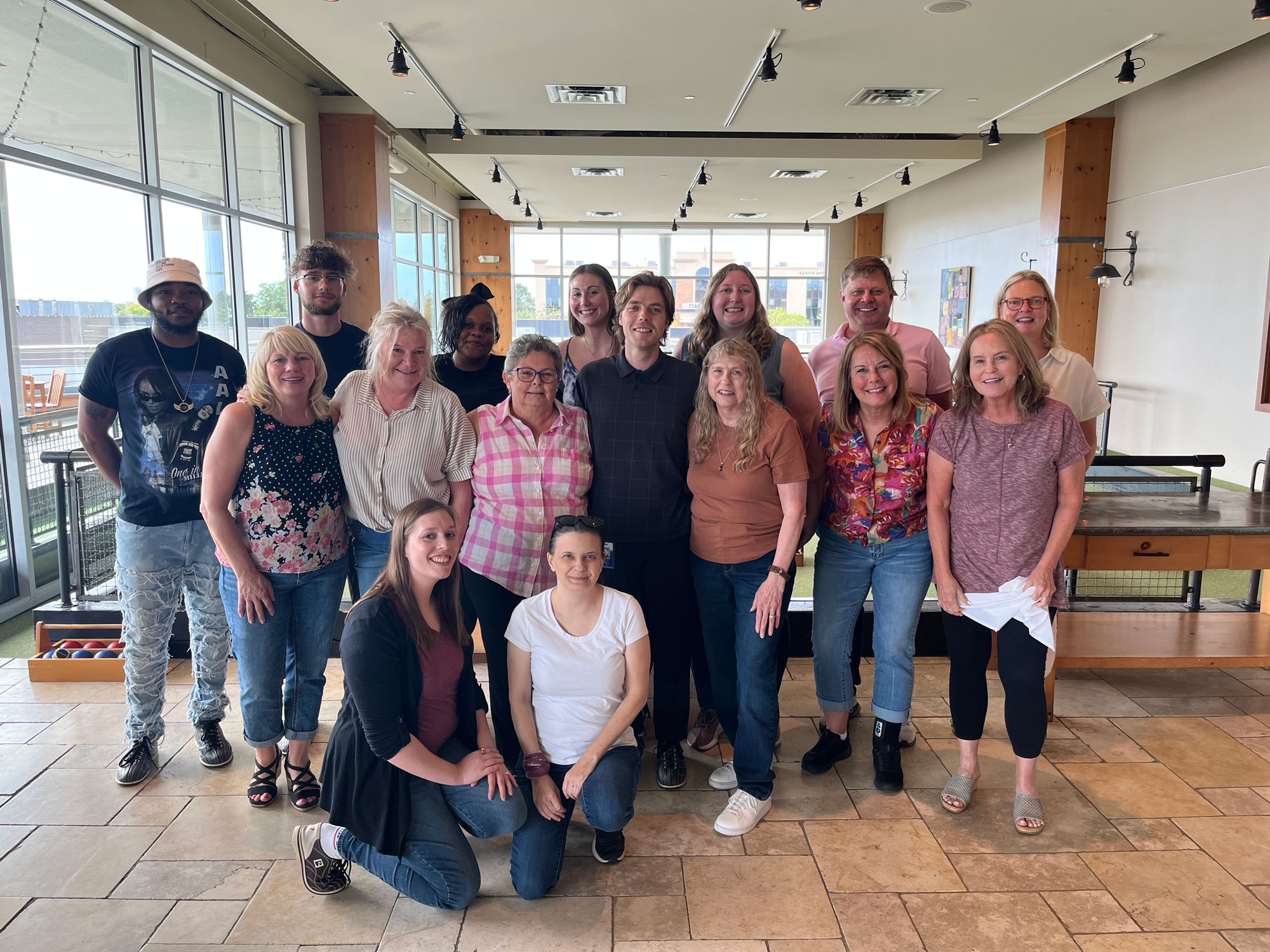 A group of employees smiling for the camera at a team building event.