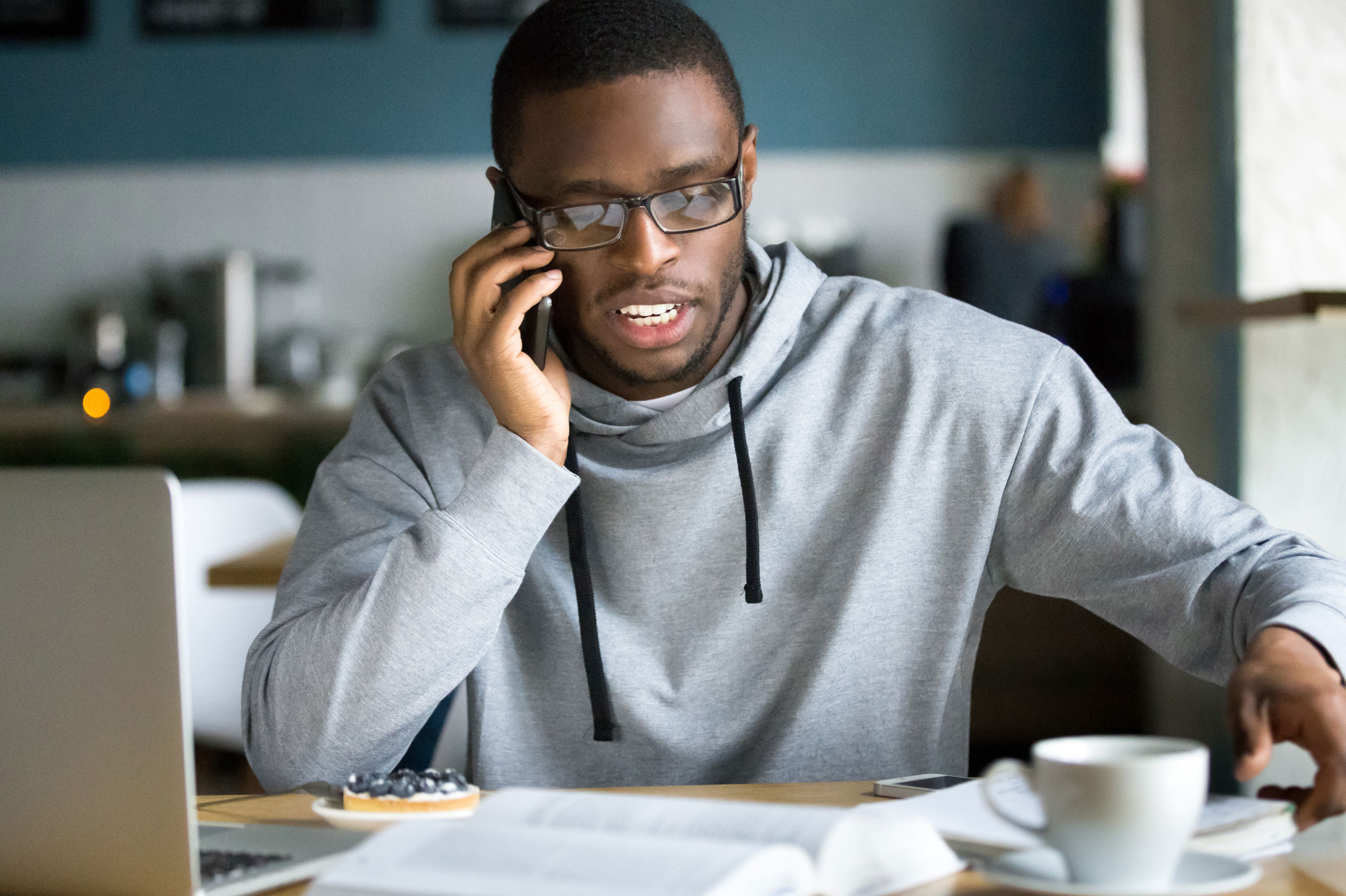 Man sitting down talking on the phone.